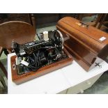 A Vesta electric sewing machine in a mahogany case