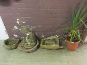 Three various concrete garden ornaments together with a potted plant