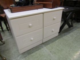 A pair of cream, two drawer bedside cabinets