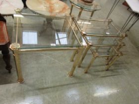Modern brass and glass topped square coffee table, together with a similar nest of three tables