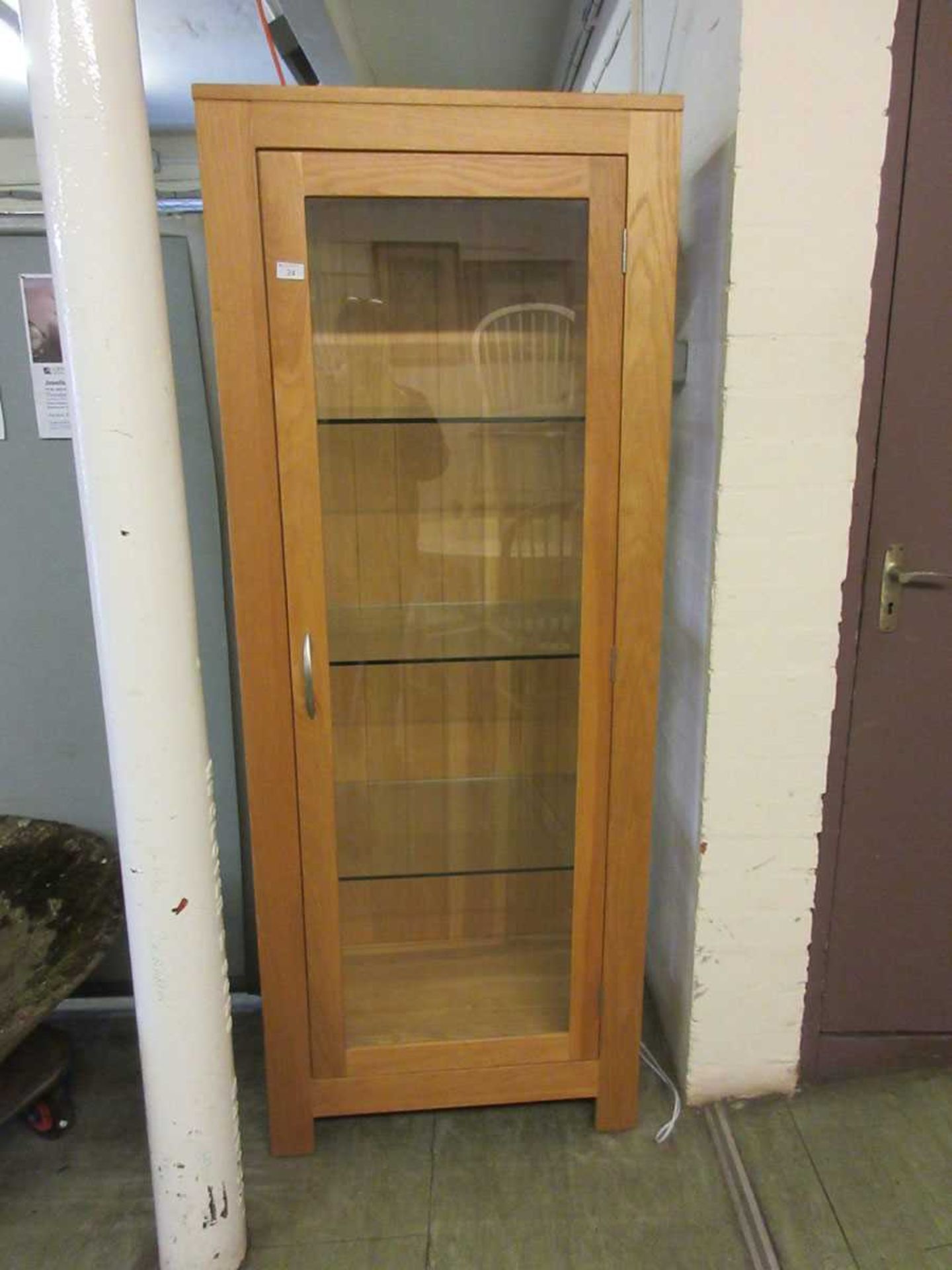 A modern light oak and glazed display cabinet