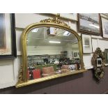 A reproduction gilt framed over mantle mirror