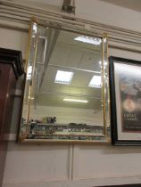 A modern gilt framed and beveled, rectangular wall mirror