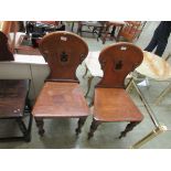 A pair of Victorian oak hall chairs