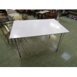 A modern white and chrome legged rectangular table