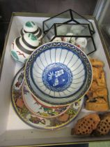 A carton containing eastern style plates, carved figures, ginger jars, etc