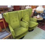 A pair of swivel easy chairs upholstered in lime green