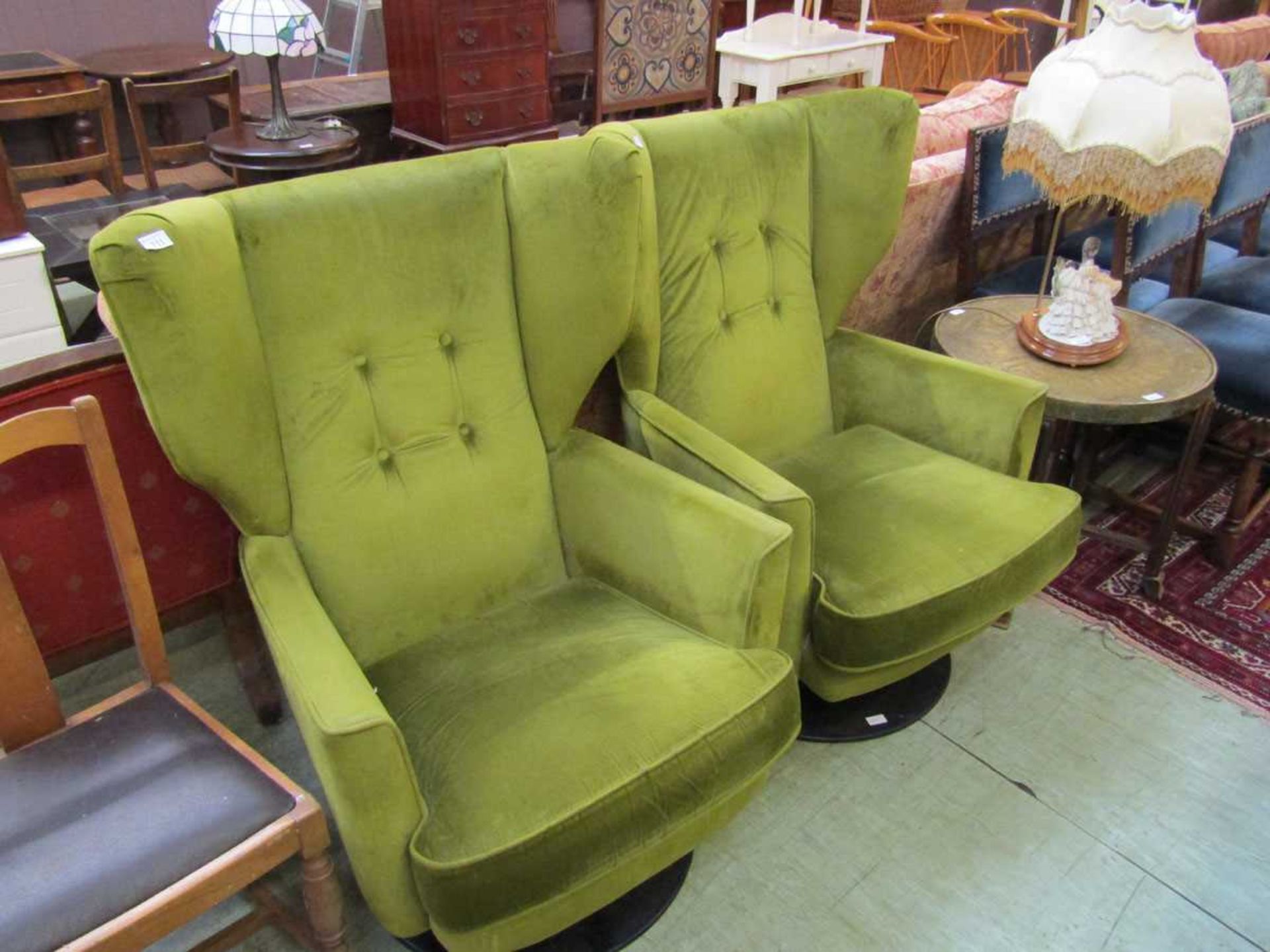 A pair of swivel easy chairs upholstered in lime green