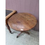 An antique elm and oak circular tripod table