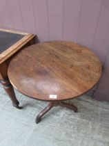 An antique elm and oak circular tripod table