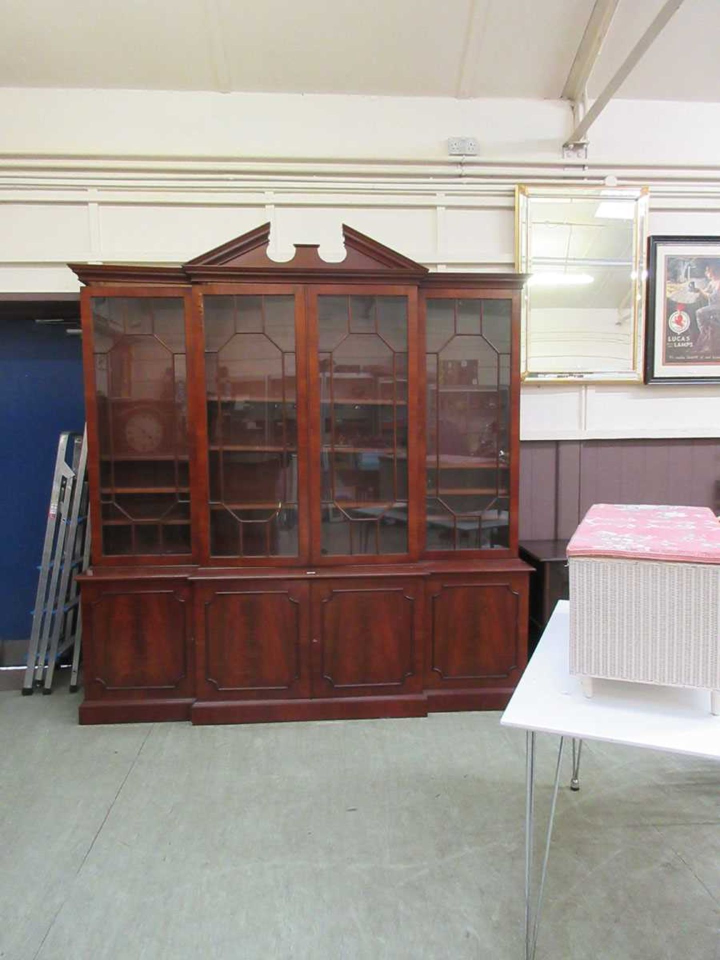 A reproduction mahogany and glazed breakfront display cabinet with cupboards under