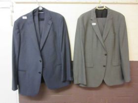 Two men's three piece suits, one marked as Armani, one marked as Hugo Boss