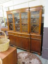 A reproduction yew breakfront display cabinet