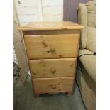 A modern pine chest of three drawers