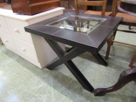A modern leather and glass topped square occasional table