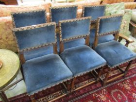 A set of six late Victorian oak Jacobean style dining chairs, with upholstered backs and seats on