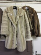 Two ladies fur coats, one of which is labelled Faulkes, Edgbaston, Birmingham, I5, no'd 20592 No