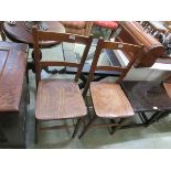 A pair of elm seat school chairs