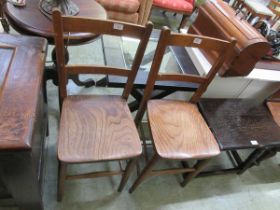 A pair of elm seat school chairs