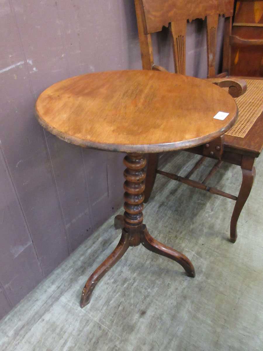 An antique mahogany bobbin turned tripod table with circular top