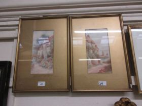A pair of framed and glazed watercolours depicting cottage scenes