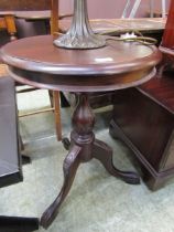 A modern, carved mahogany circular topped table