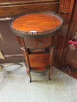 A reproduction circular gallery top occasional table, with shelf to the under tier