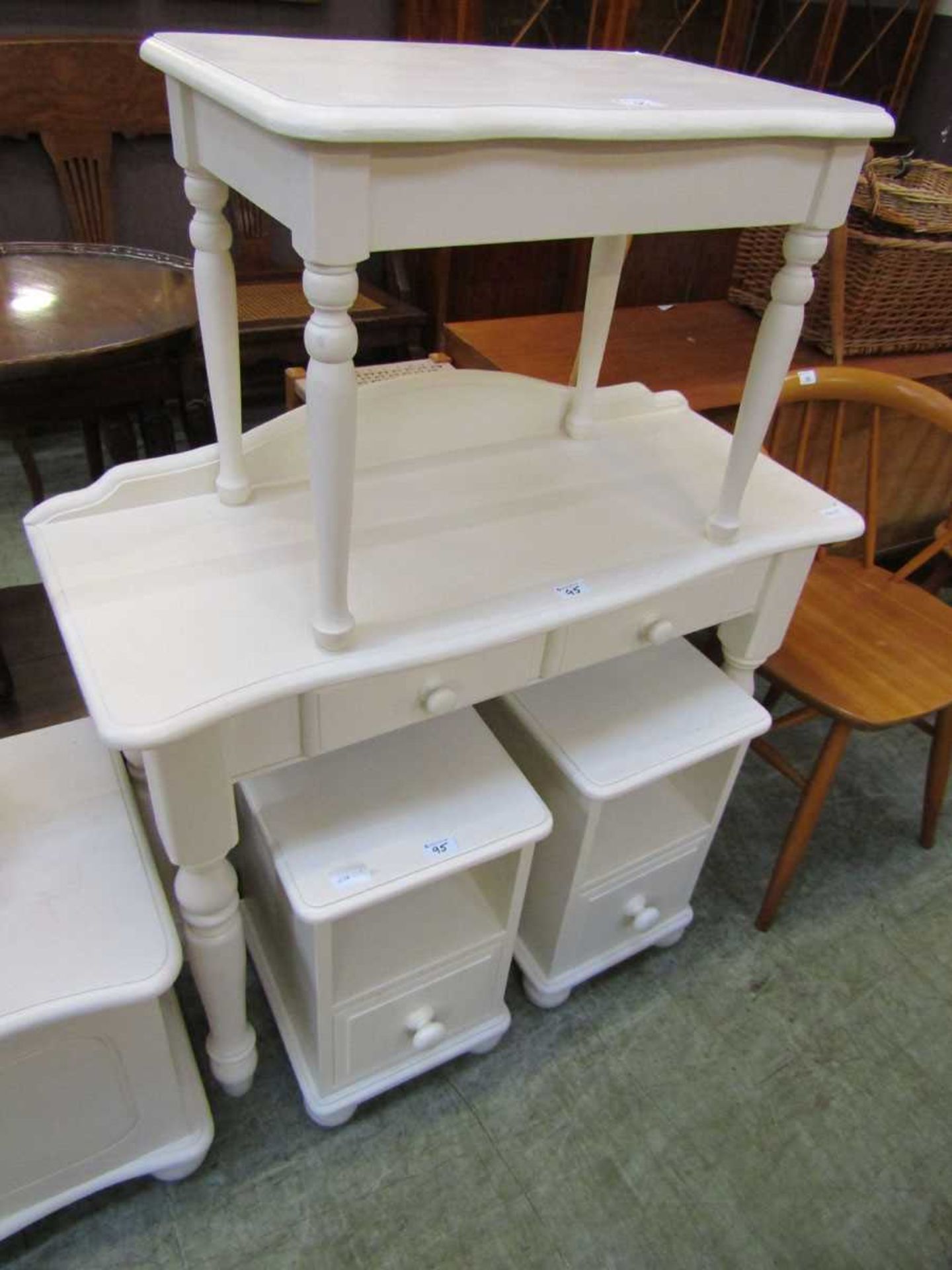 A modern cream painted dressing table together with stool and pair of matching bedside cabinets