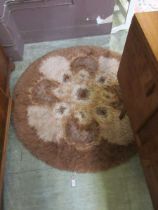 A brown circular wool rug