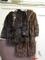 A brown fur coat by Faulkes Furriers together with one other