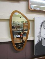 A mid-20th century teak framed wall mirror