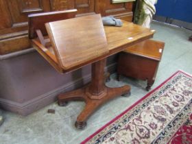A Victorian mahogany double sided reading or music table on pedestal