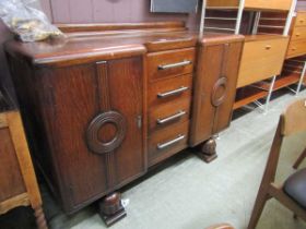 A mid-20th century oak sideboard having four drawers with chrome handles flanked by cupboard doors