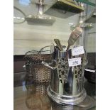 Two wirework baskets together with a plated wine bottle holder and an assortment of flatware