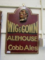 A reproduction wooden advertising pub plaque 'Wig and Gown'
