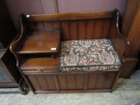 A mid-20th century oak telephone table