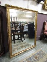 A large reproduction gilt framed bevel glass wall mirror