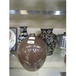 An oriental cloisonné style black ground vase with floral design along with a brown glazed vase with