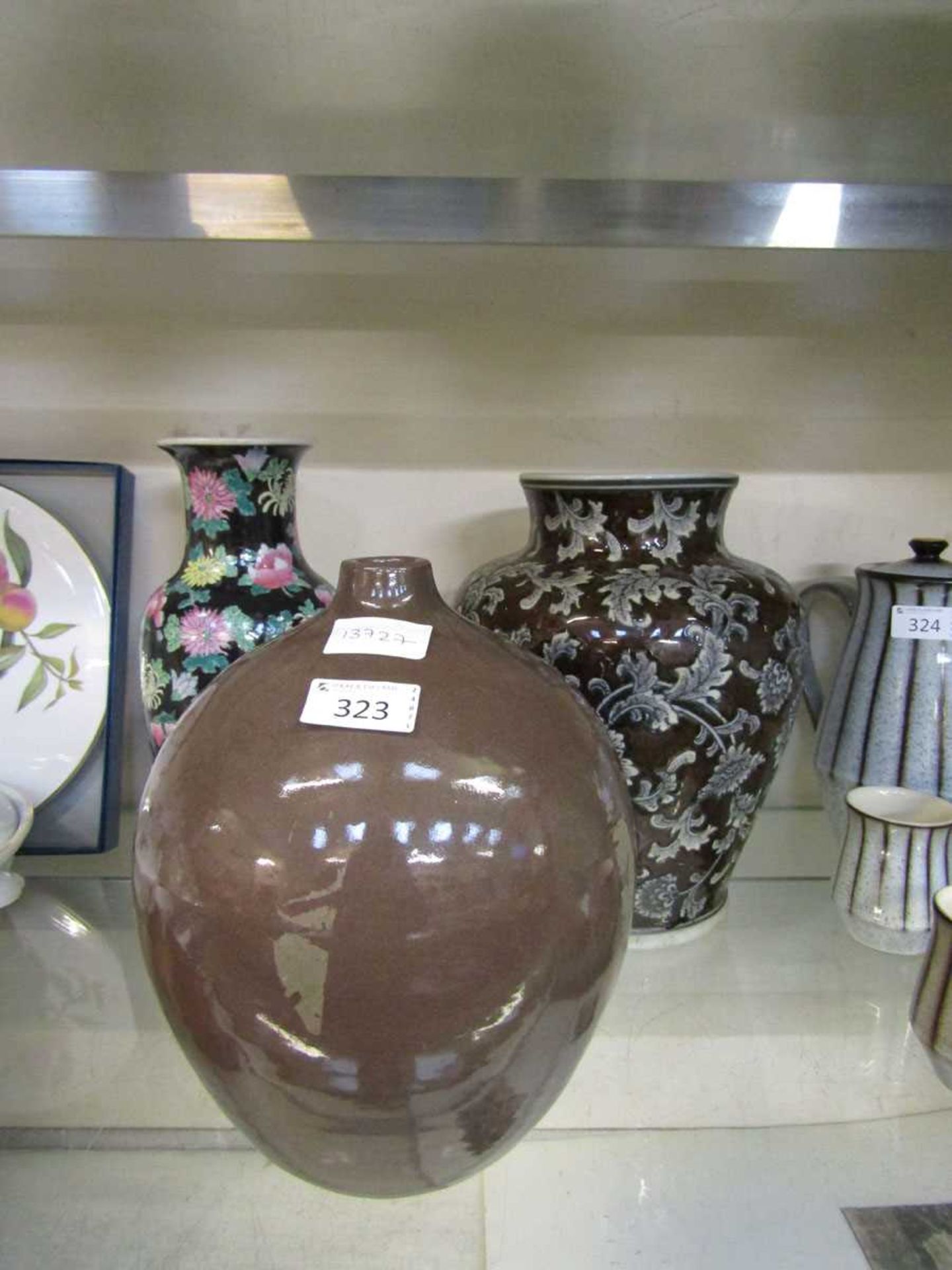 An oriental cloisonné style black ground vase with floral design along with a brown glazed vase with