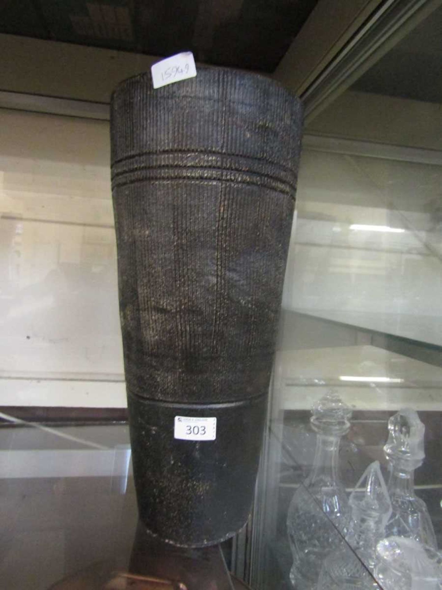 A black glazed stoneware vase with embossed line design