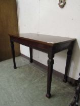 An Edwardian mahogany Hepplewhite style console table with square tapering fluted legs
