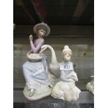 Two Lladro figurines of girl with a swan and girl with a lamb