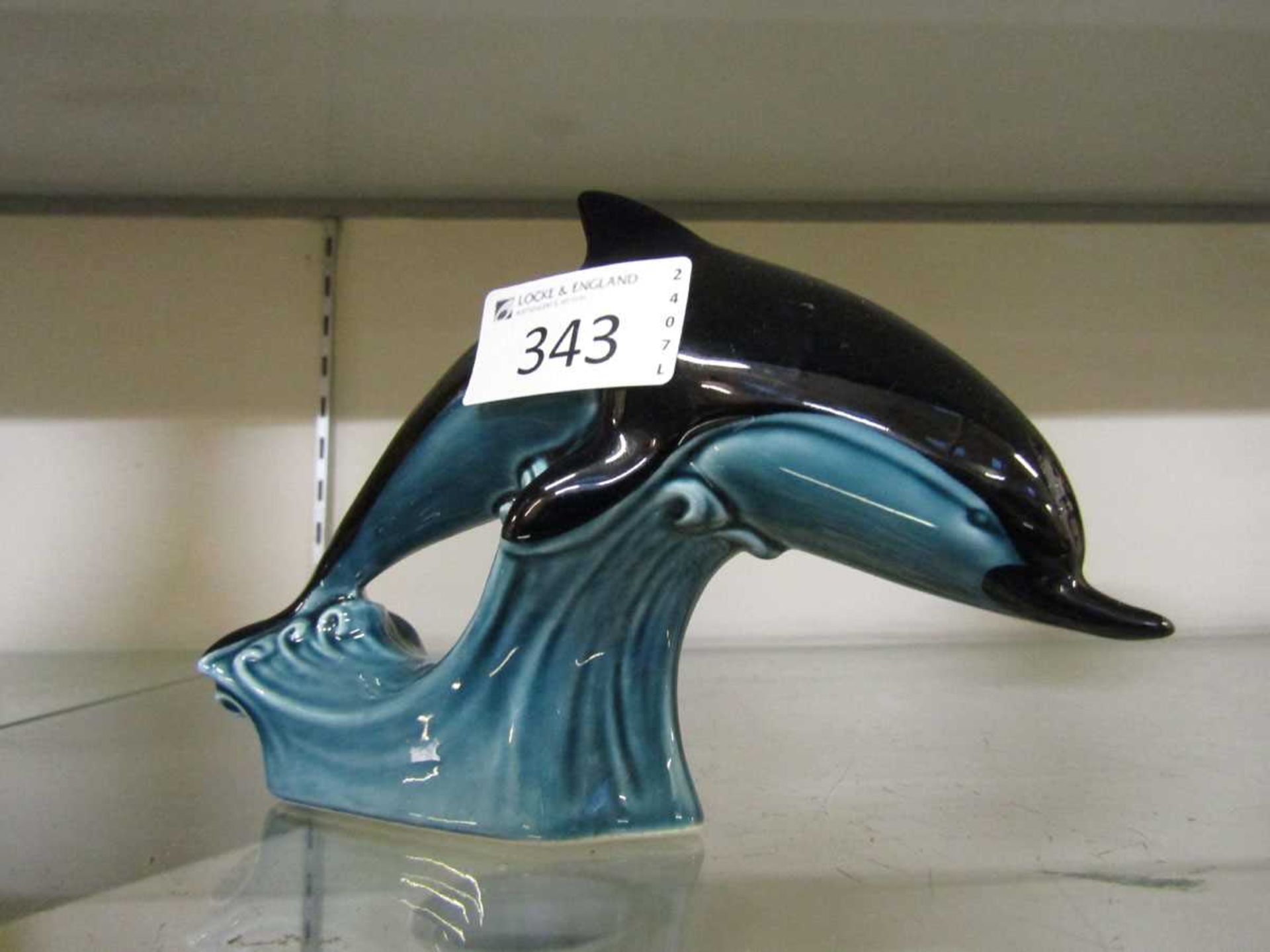 A Poole Pottery ceramic figurine of a dolphin