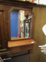 A late Victorian mahogany wall mounted hall mirror with glove drawer