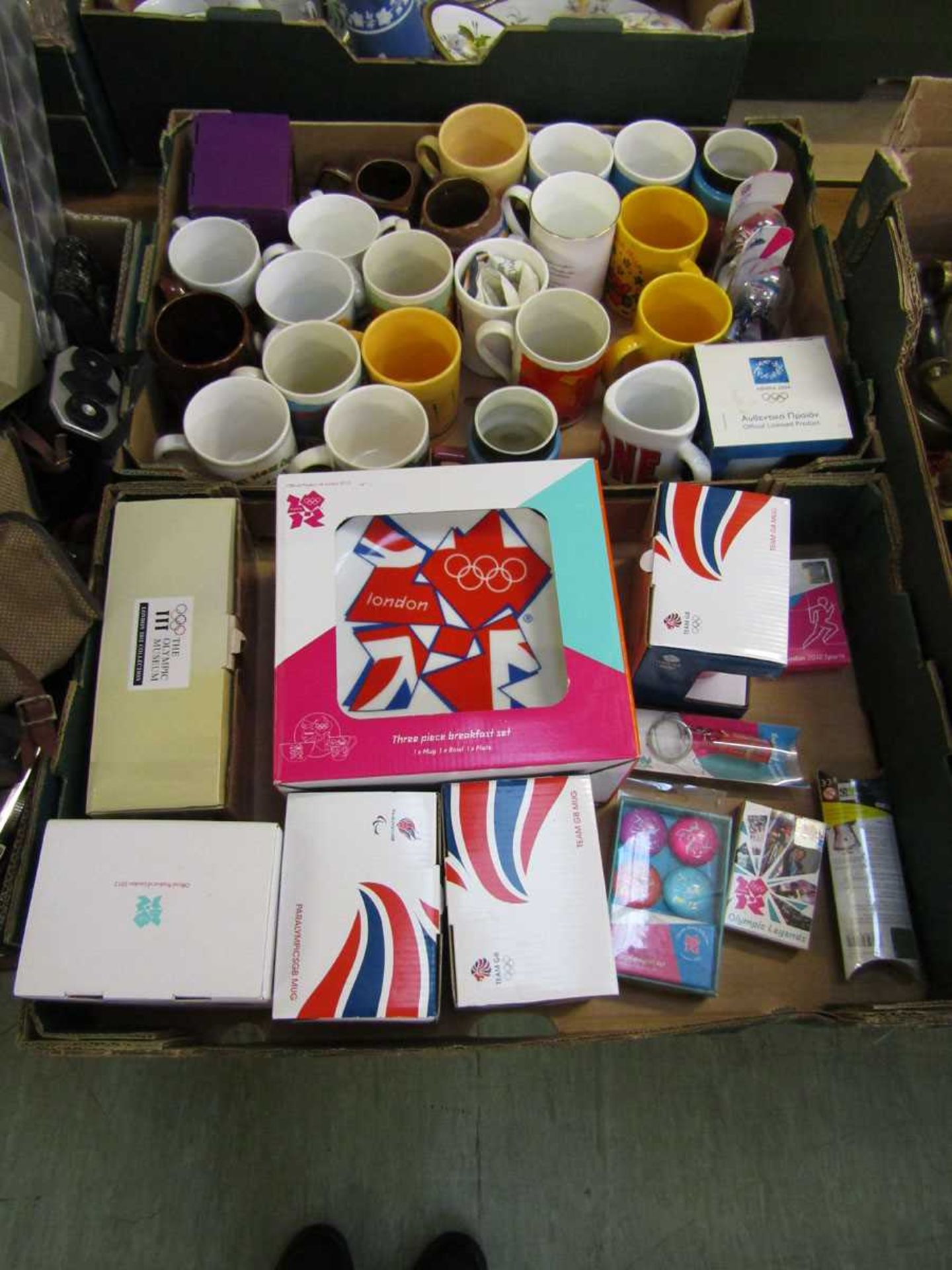Two trays of decorative ceramic ware to include collector's mugs, boxed 2012 London Olympics