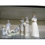 Lladro ceramic figurines along with one Nao figurine consisting of young girl and boy praying,