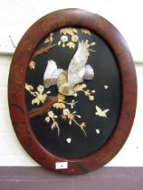 A reproduction oriental oval plaque of bird of prey