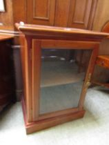 A reproduction glazed music cabinet