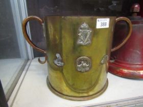 A large trench art twin handled pot with medallions to side, marked to base 'March 7th 1916 -