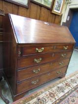 A Georgian mahogany fall front bureau having a part fitted interior with four graduated drawers